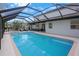 A long screened in pool next to the house with outdoor seating areas at 12001 Backwater Rd, Sarasota, FL 34240