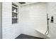 Modern shower featuring subway tile, a rainfall shower head, and a built in shelf at 12001 Backwater Rd, Sarasota, FL 34240