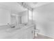 Bathroom featuring double sinks, a large mirror, and ample countertop space at 16606 San Nicola Pl, Lakewood Ranch, FL 34211