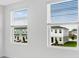 Bedroom view of neighboring homes and landscape through bright, light filled windows at 16606 San Nicola Pl, Lakewood Ranch, FL 34211