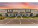 Well-maintained two-story townhomes with blue front doors, landscaping, and ample parking spaces at 16606 San Nicola Pl, Lakewood Ranch, FL 34211