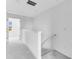 Bright hallway with neutral carpeting, lots of light and staircase to lower level at 16606 San Nicola Pl, Lakewood Ranch, FL 34211
