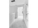 Bright hallway with neutral carpeting and views to bedrooms with lots of light at 16606 San Nicola Pl, Lakewood Ranch, FL 34211