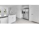 Modern, bright kitchen with stainless steel appliances, white cabinetry, and island with sink at 16606 San Nicola Pl, Lakewood Ranch, FL 34211
