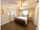 Inviting bedroom features a ceiling fan, bedside tables and natural light at 241 Seminole Nw Blvd, Port Charlotte, FL 33952