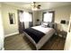 Cozy bedroom featuring a queen-sized bed, ceiling fan, and natural light from the window at 241 Seminole Nw Blvd, Port Charlotte, FL 33952