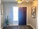 Inviting entryway with a dark wood door, decorative glass sidelight, and stylish decor at 241 Seminole Nw Blvd, Port Charlotte, FL 33952