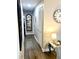 Hallway with hardwood floors, light-colored walls, and decorative mirror with modern accents at 241 Seminole Nw Blvd, Port Charlotte, FL 33952