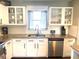 Bright kitchen featuring granite counters, subway tile backsplash, and stainless appliances at 241 Seminole Nw Blvd, Port Charlotte, FL 33952