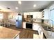 Well-lit kitchen with stainless steel appliances, white cabinets, and granite countertops at 241 Seminole Nw Blvd, Port Charlotte, FL 33952