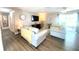 Cozy living room featuring neutral colors, hardwood floors, and sliding door access to a patio at 241 Seminole Nw Blvd, Port Charlotte, FL 33952