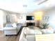 Comfortable living room featuring a large sofas, modern decor, and hardwood floors at 241 Seminole Nw Blvd, Port Charlotte, FL 33952