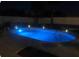 Stunning backyard swimming pool illuminated at night at 241 Seminole Nw Blvd, Port Charlotte, FL 33952