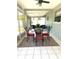 Enclosed sunroom with tile flooring and a table set for four, perfect for outdoor dining at 241 Seminole Nw Blvd, Port Charlotte, FL 33952