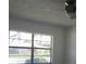 Bright bedroom featuring a large window offering a pleasant neighborhood view at 3314 Mcdill Rd # 3314, Bradenton, FL 34207