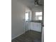 Well-lit kitchen features white cabinets, gray wood flooring and a ceiling fan at 3314 Mcdill Rd # 3314, Bradenton, FL 34207