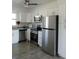 Bright kitchen with stainless steel appliances, white cabinets, and modern fixtures at 3314 Mcdill Rd # 3314, Bradenton, FL 34207