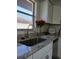 Modern kitchen sink with granite counters and view of backyard through the window at 3314 Mcdill Rd # 3314, Bradenton, FL 34207