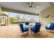 Screened lanai with dining set overlooking a sparkling pool and lush tropical landscape at 3607 Darin Dr, Punta Gorda, FL 33950