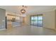 Open-concept living room featuring tile floors, sliding glass doors, and a view of the water at 3628 Scrub Creek Run, Bradenton, FL 34211