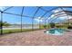 Screened-in pool area with brick patio and water views at 3628 Scrub Creek Run, Bradenton, FL 34211