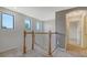 Bright stairway landing features carpet floors, wood railing and natural light from windows at 3628 Scrub Creek Run, Bradenton, FL 34211