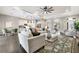 Open-concept living room with modern furniture, a ceiling fan, and seamless flow to the kitchen at 5203 Lake Overlook Ave, Bradenton, FL 34208