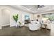 Spacious living room with neutral tones, modern ceiling fan, and seamless indoor-outdoor flow at 5203 Lake Overlook Ave, Bradenton, FL 34208