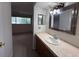 Bathroom featuring granite countertops, updated mirror, vanity, and great lighting at 1007 Longfellow Cir, Sarasota, FL 34243