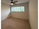 Neutral bedroom featuring carpet, a window with natural light, and a ceiling fan at 1007 Longfellow Cir, Sarasota, FL 34243