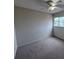 This bedroom is carpeted and includes a window and ceiling fan with lights at 1007 Longfellow Cir, Sarasota, FL 34243