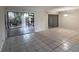 Bright living room features tiled floors and sliding glass doors to a patio at 1007 Longfellow Cir, Sarasota, FL 34243