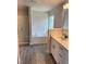 Elegant bathroom featuring a soaking tub, glass-enclosed shower, and a stylish vanity with great lighting at 2644 Averland Loop, North Port, FL 34287