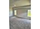 Spacious bedroom with plush gray carpeting, neutral walls, and plenty of natural light from the two windows at 2644 Averland Loop, North Port, FL 34287