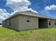 View of the home's backyard, displaying a covered lanai and minimal landscaping at 2648 Averland Loop, North Port, FL 34287