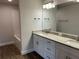 Bathroom with double vanity, granite countertop, and tiled shower at 2648 Averland Loop, North Port, FL 34287