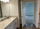 Bathroom with granite countertop, white cabinets, and tile floor at 2648 Averland Loop, North Port, FL 34287