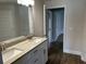 Bathroom featuring a double vanity with granite countertops and wood-look tile flooring at 2648 Averland Loop, North Port, FL 34287