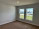 Bright bedroom featuring neutral carpet, walls, and two windows offering natural light at 2648 Averland Loop, North Port, FL 34287