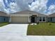 Charming single-story home featuring a two-car garage, neutral stucco, and well-maintained landscaping at 2648 Averland Loop, North Port, FL 34287