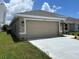 Two-car garage with neutral door, exterior lanterns, and freshly poured driveway, offering ample parking at 2648 Averland Loop, North Port, FL 34287