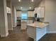 Bright kitchen featuring white cabinets, modern appliances, granite countertops, and open access to the living room at 2648 Averland Loop, North Port, FL 34287