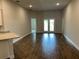 An open living room with wood-look tile flooring and view to the lanai, perfect for modern living at 2648 Averland Loop, North Port, FL 34287