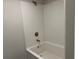 Shower featuring white tile surround and modern fixtures at 2648 Averland Loop, North Port, FL 34287