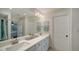 Elegant bathroom featuring double sinks, a large mirror, and modern fixtures at 4600 Gulf Of Mexico Dr # 206, Longboat Key, FL 34228