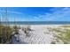 Beautiful beach with white sand, clear blue water, and natural dunes at 4600 Gulf Of Mexico Dr # 206, Longboat Key, FL 34228