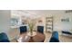 Charming dining area with wood table, blue upholstered chairs, and kitchen view at 4600 Gulf Of Mexico Dr # 206, Longboat Key, FL 34228