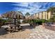 Outdoor barbeque area with tiki huts and picnic tables with stainless grill at 5740 Midnight Pass Rd # 307, Sarasota, FL 34242