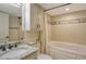 Bright bathroom featuring a bathtub with custom tile surround and a granite vanity at 5740 Midnight Pass Rd # 307, Sarasota, FL 34242