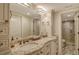 Well-lit bathroom featuring double sinks with granite countertops and custom cabinetry at 5740 Midnight Pass Rd # 307, Sarasota, FL 34242